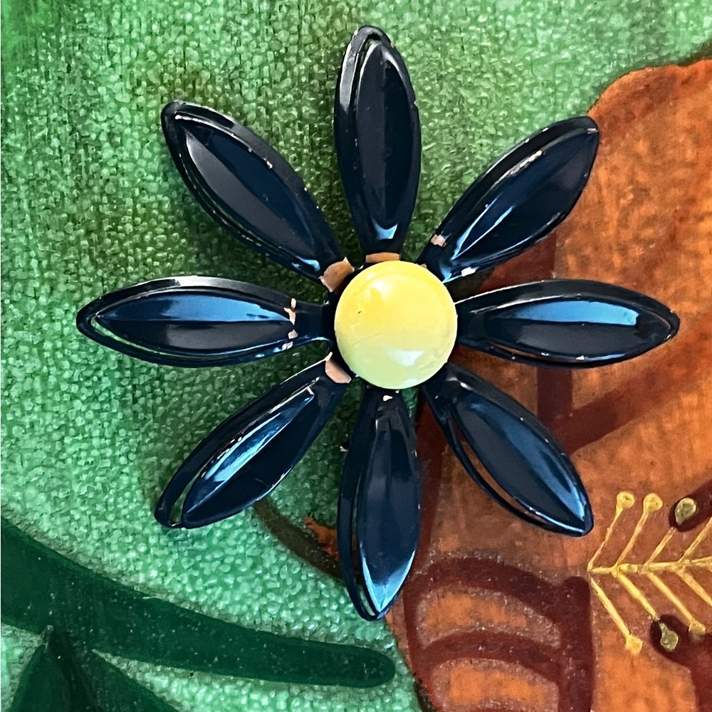 Vintage black enamel daisy flower brooch with a yellow center